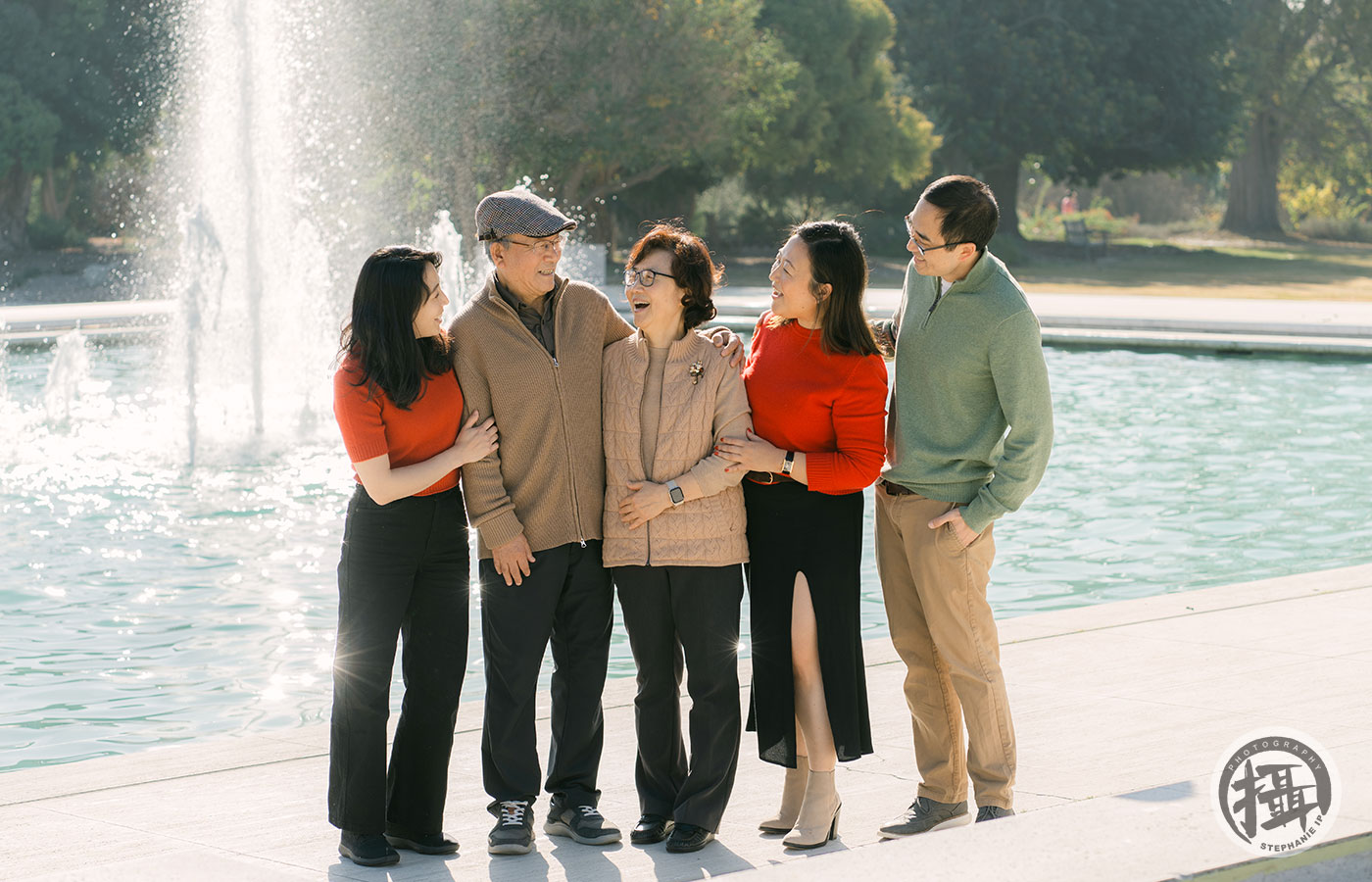 Warm lifestyle family photoshoot in Corona Del Mar park, featuring playful moments and genuine smiles.