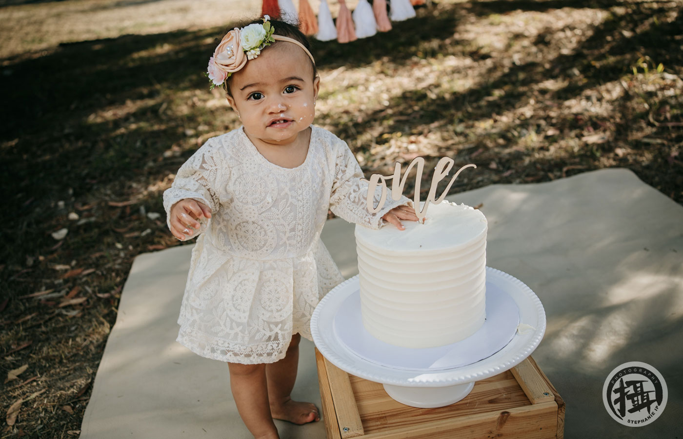 First birthday milestone photoshoot in Corona Del Mar park, with a whimsical cake smash by Orange County’s best family photographer.