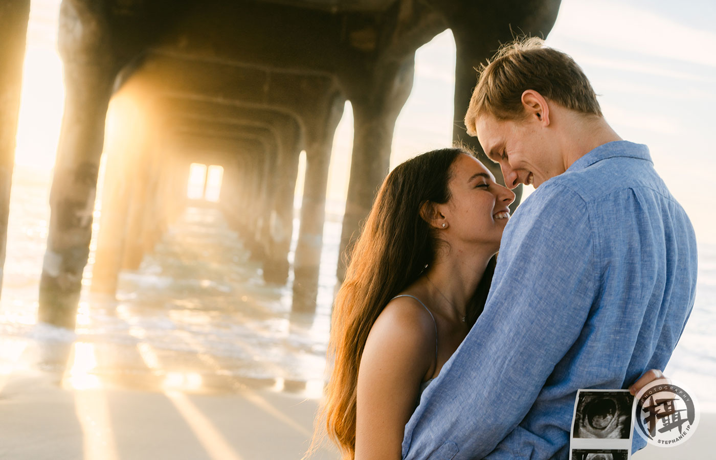 Maternity session in Huntington Beach with flowing dresses and soft coastal backdrops, captured by the best maternity photographer in Orange County.