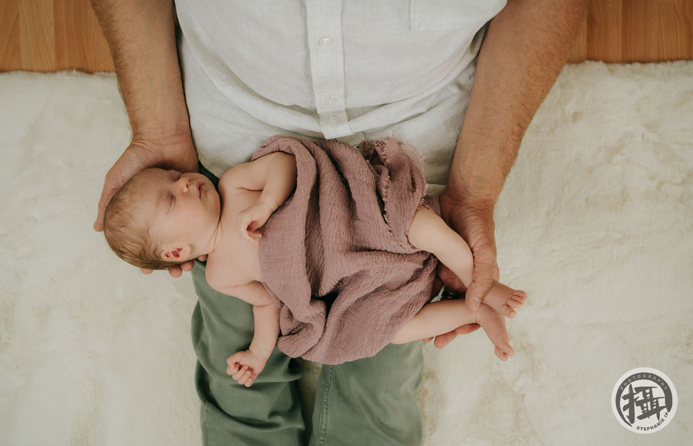 Newborn photography in Laguna Hills home, featuring parents and siblings bonding in a relaxed setting.