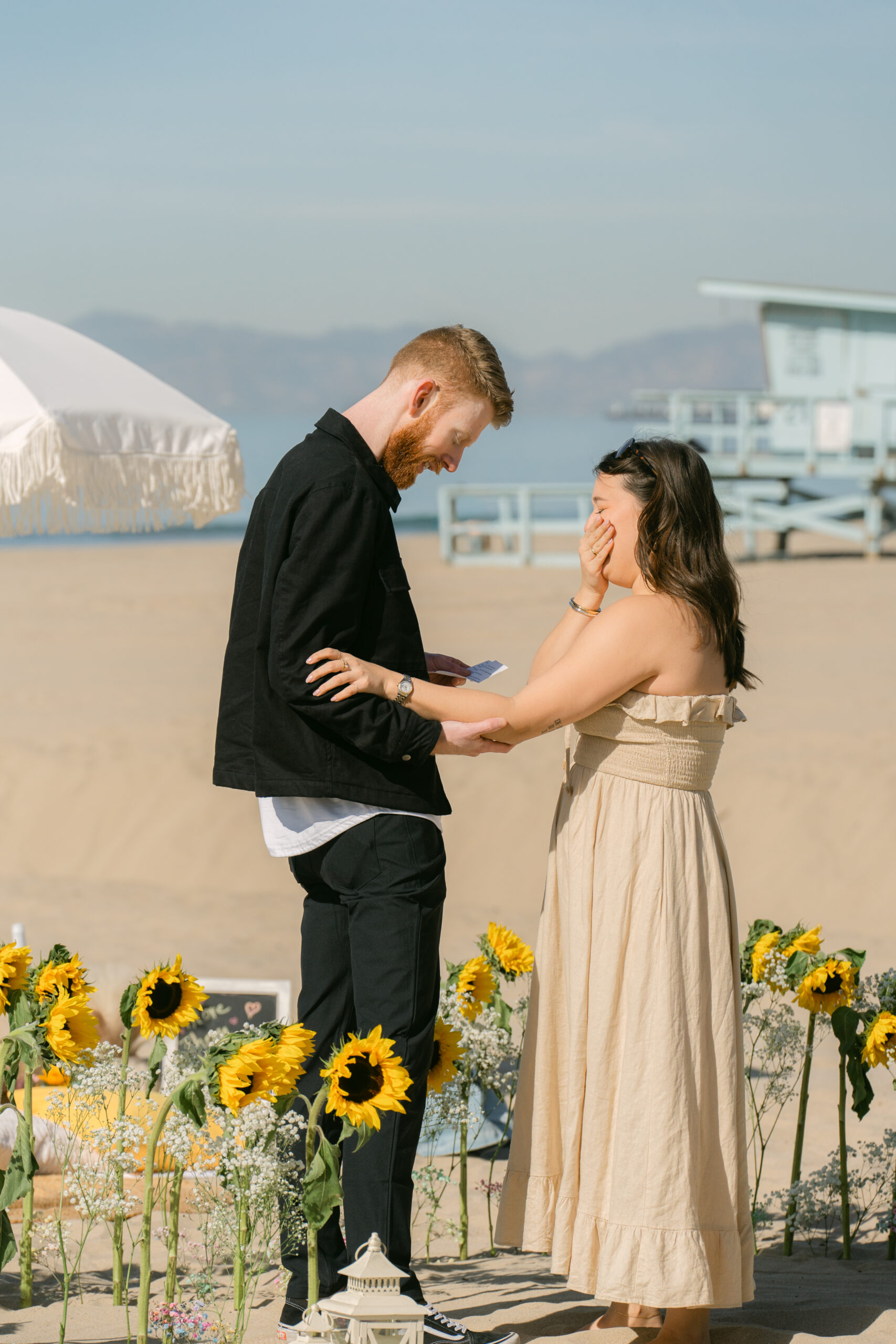 Engaged couple celebrating their proposal by the ocean in Los Angeles.