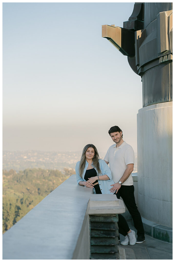 Surprise proposal setup on hiking trail at Griffith Observatory with panoramic views of Los Angeles