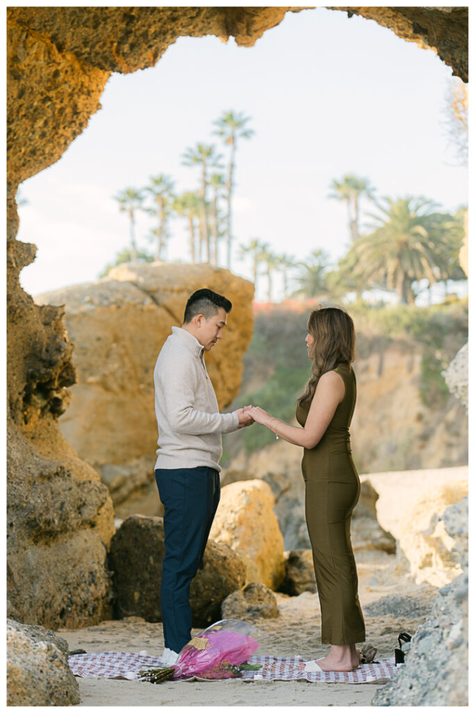 Romantic beach proposal at Treasure Island Beach Cave in Laguna Beach, California.