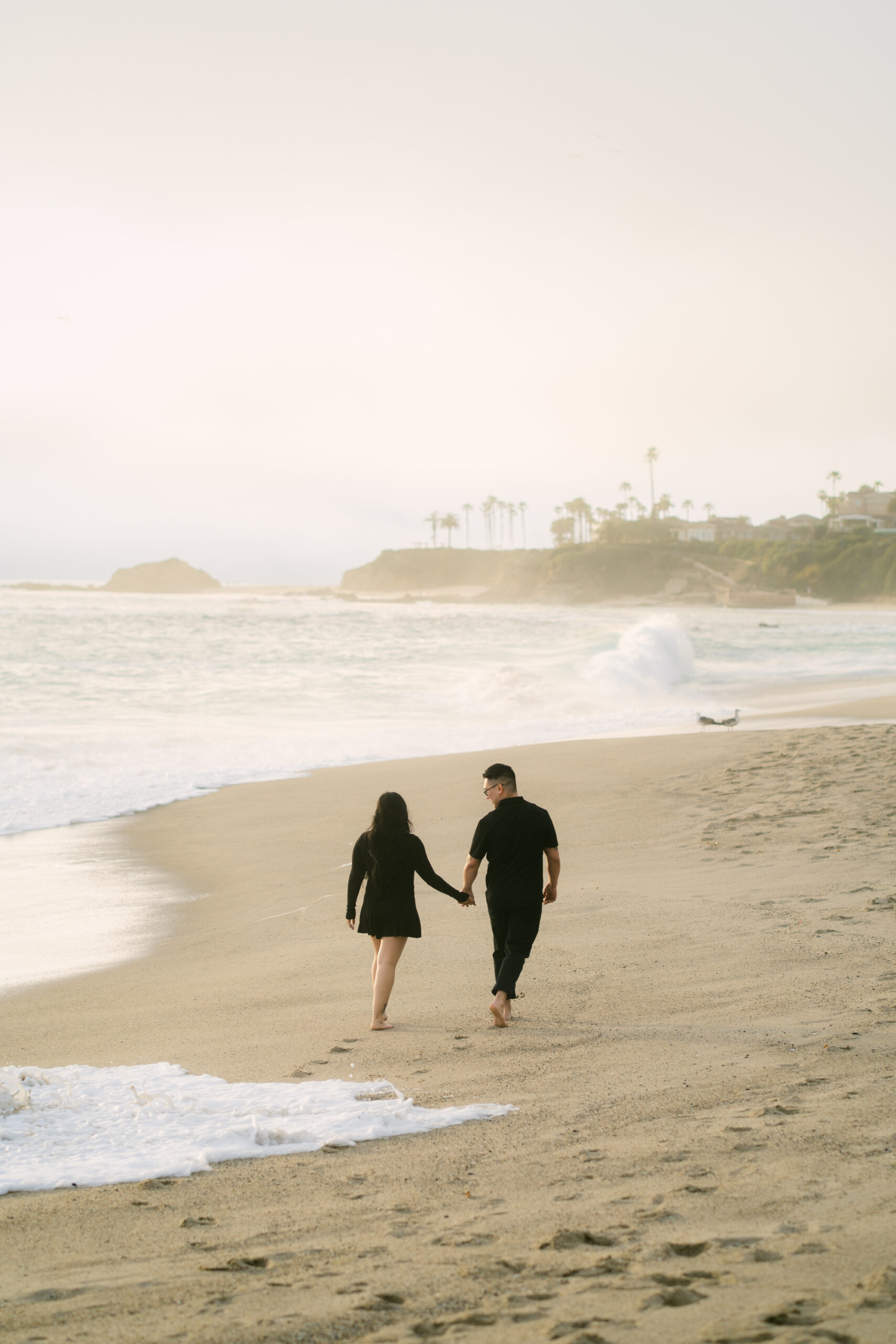 Romantic floral surprise proposal at Aliso Beach in Laguna Beach on a cloudy spring day
