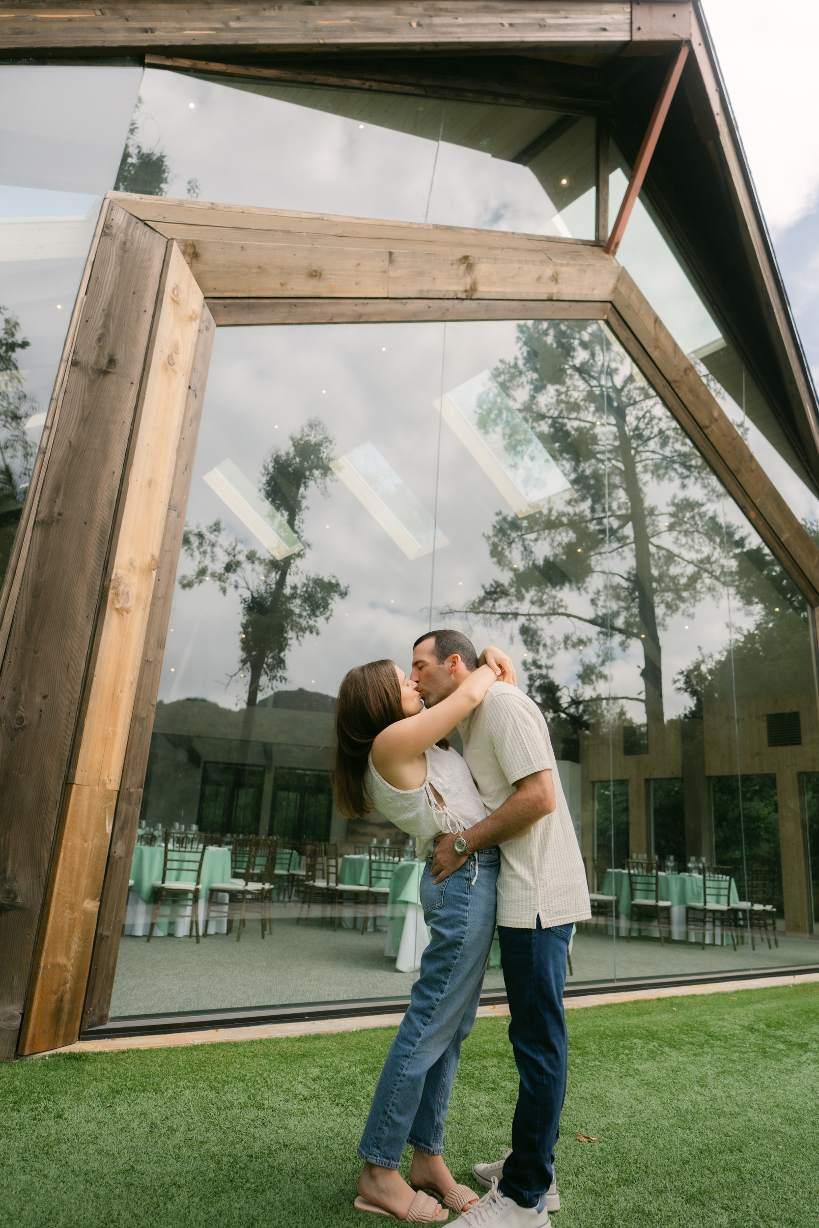Engaged couple in front of the Oak Room at Calamigos Ranch under soft overcast light