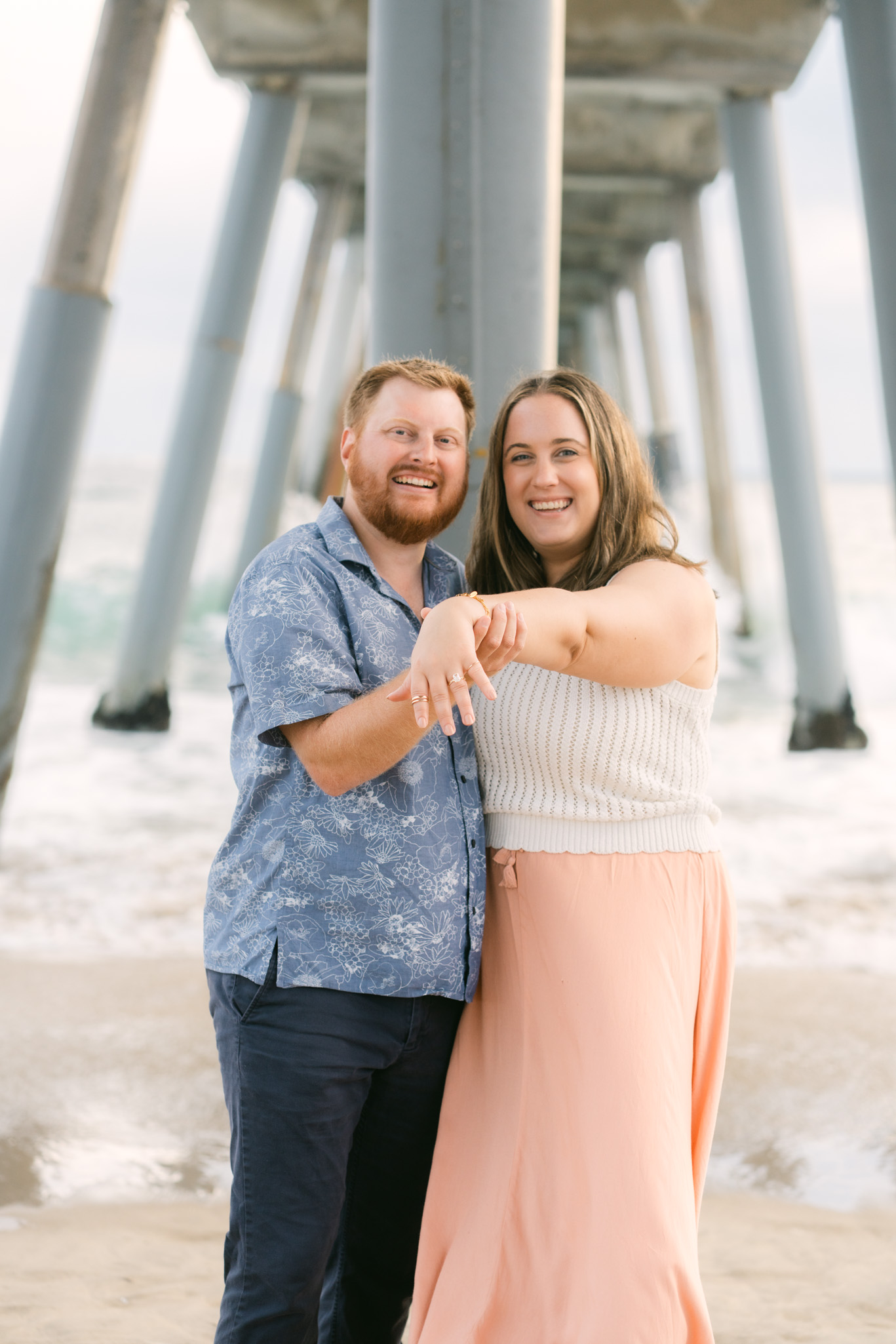 Surprise beach proposal at Hermosa Beach volleyball courts with rooftop party reveal