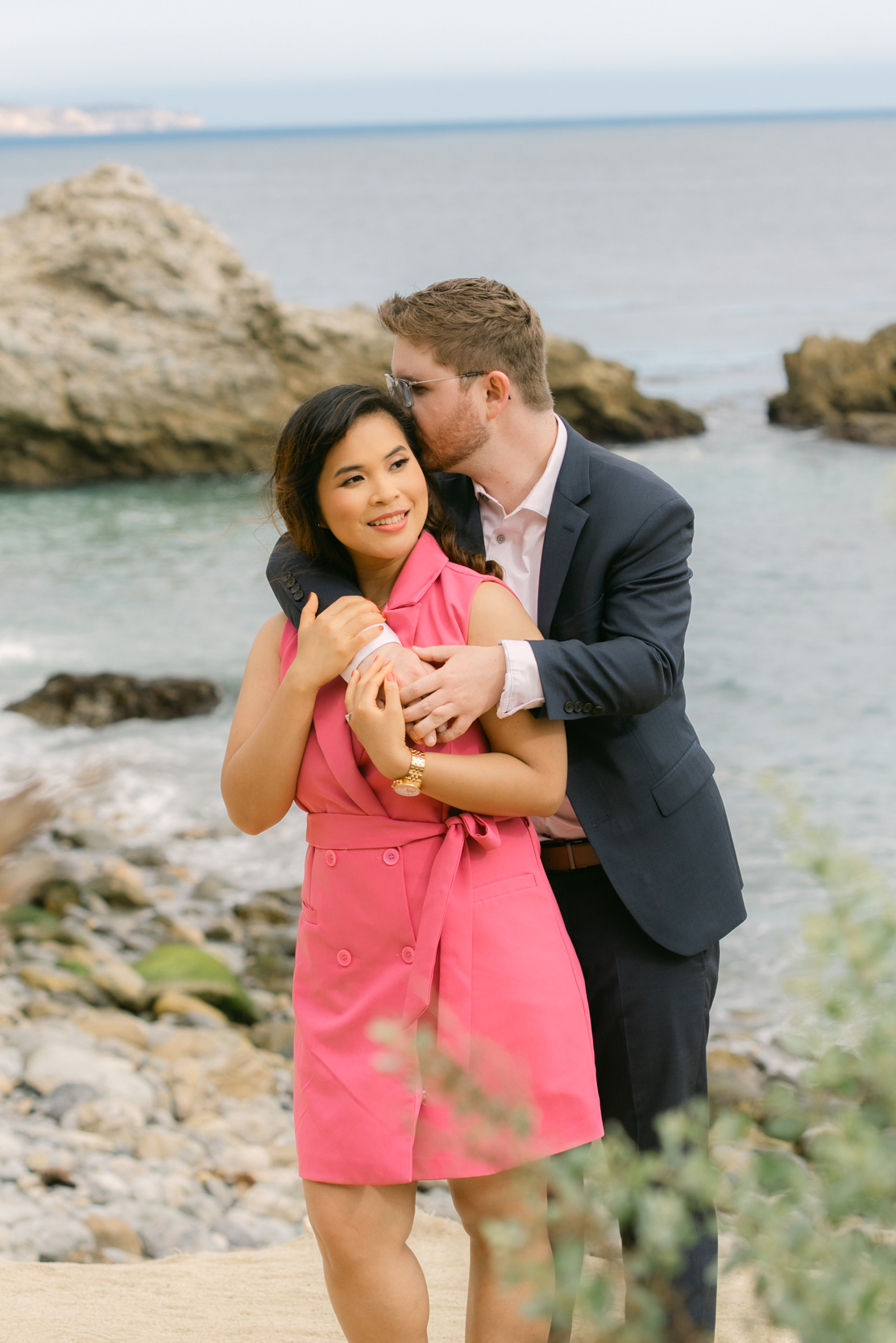 Jimmy proposing to Christine at Marineland Beach under overcast skies.