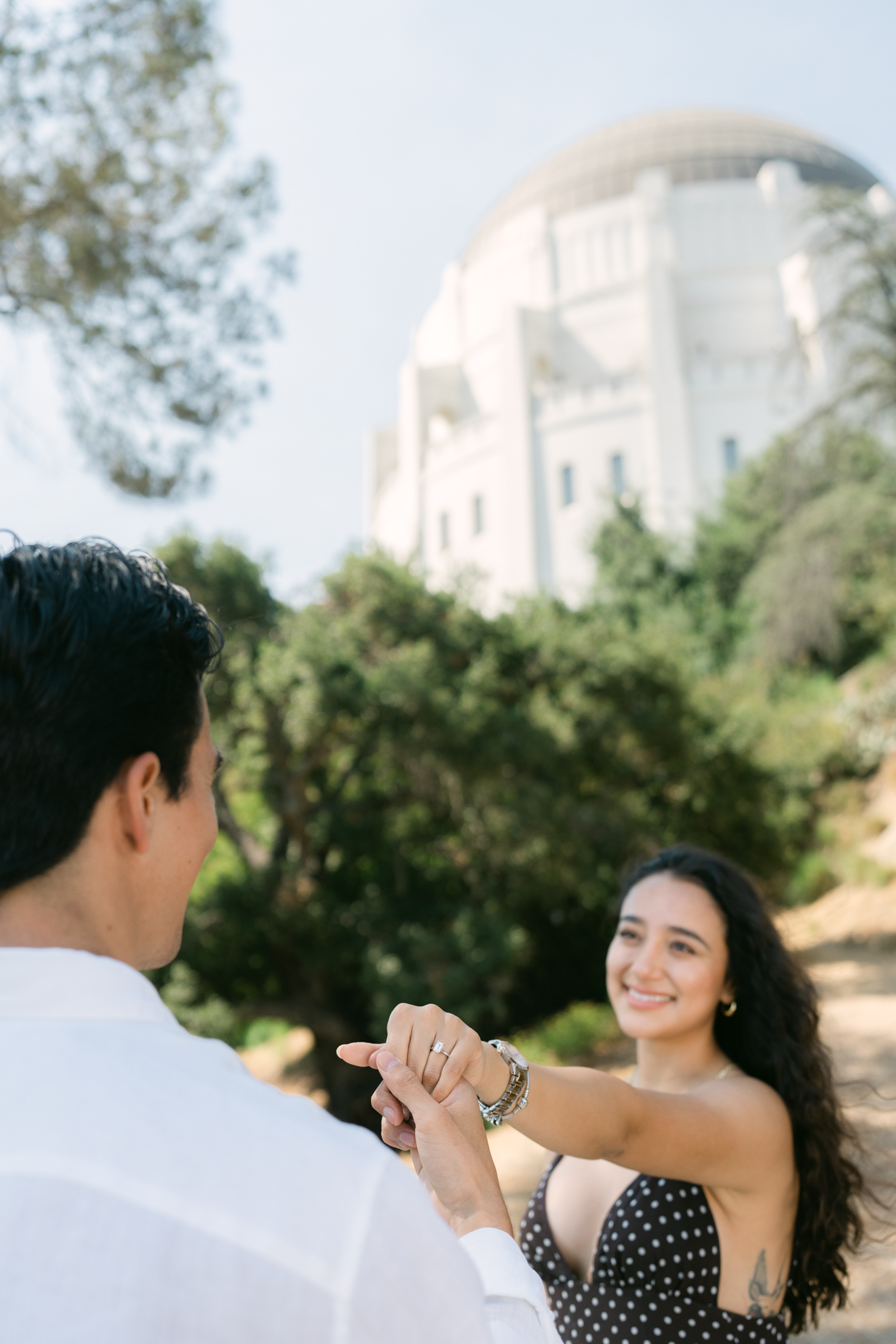 Melissa and Miguel’s surprise proposal at Griffith Observatory overlooking the Los Angeles skyline.
