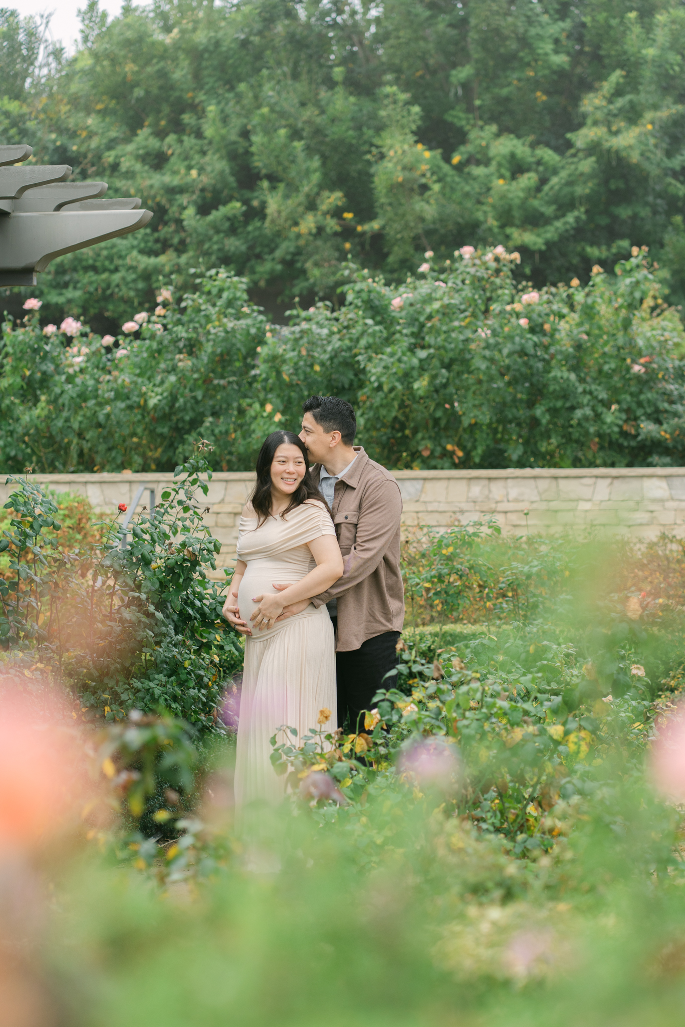 Outdoor maternity photoshoot at South Coast Botanical Garden with lush greenery and natural light