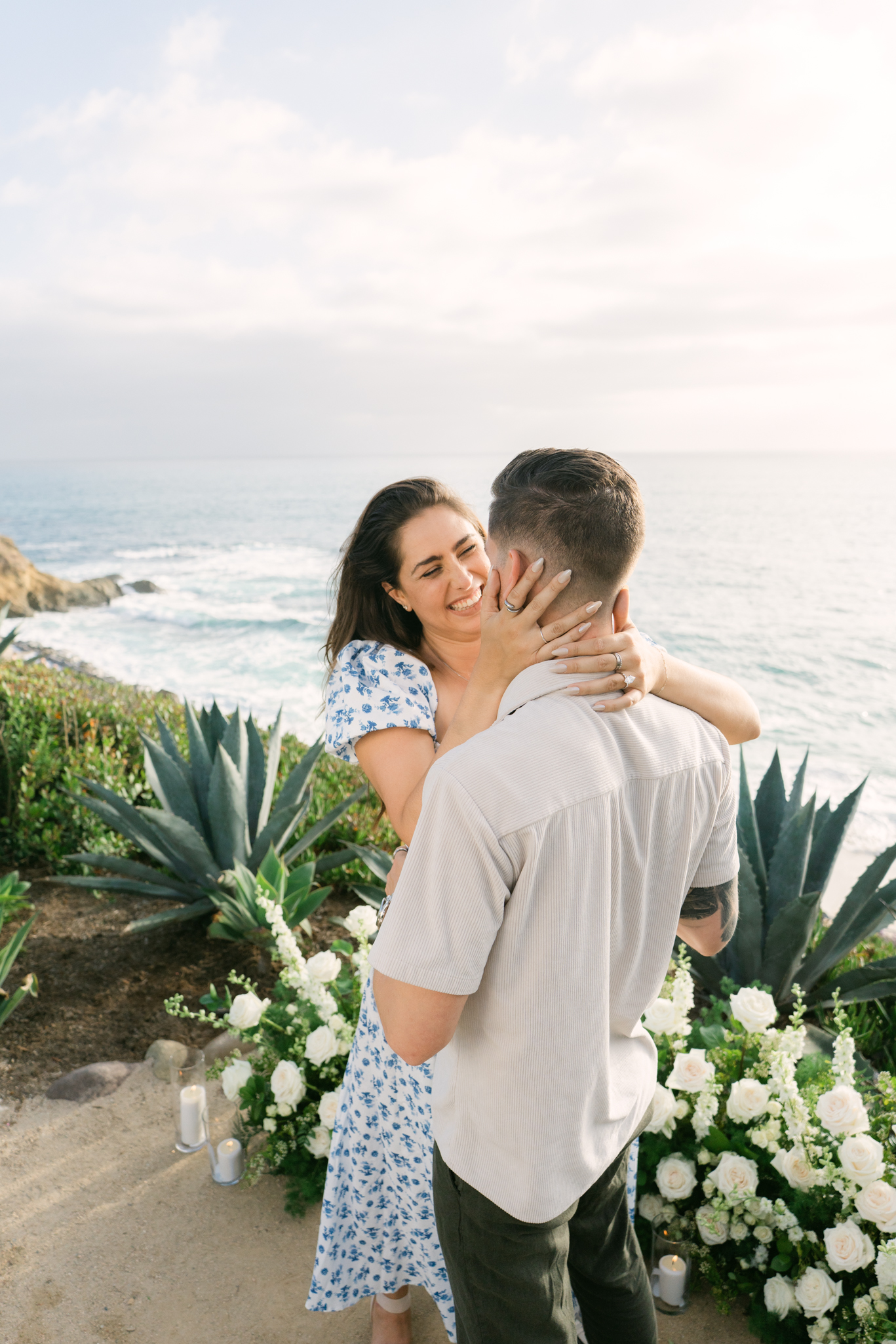 Family-inclusive surprise proposal at Treasure Island Beach in Laguna Beach overlooking the ocean
