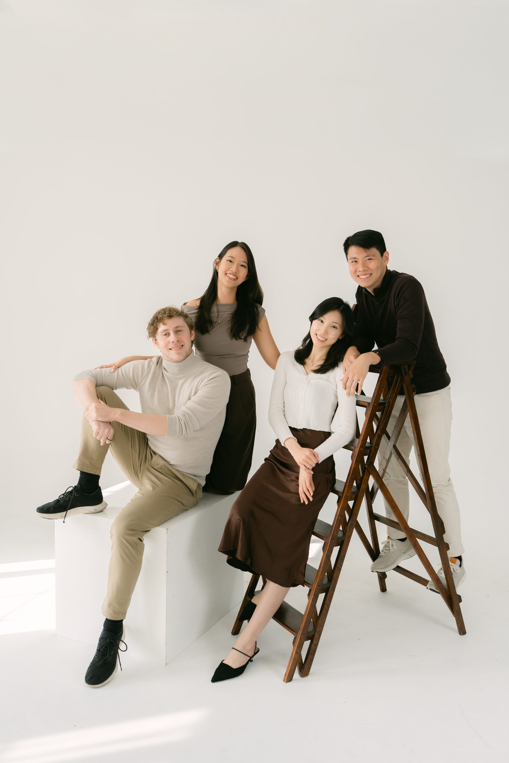 Adult siblings photographed together at a Los Angeles studio family session