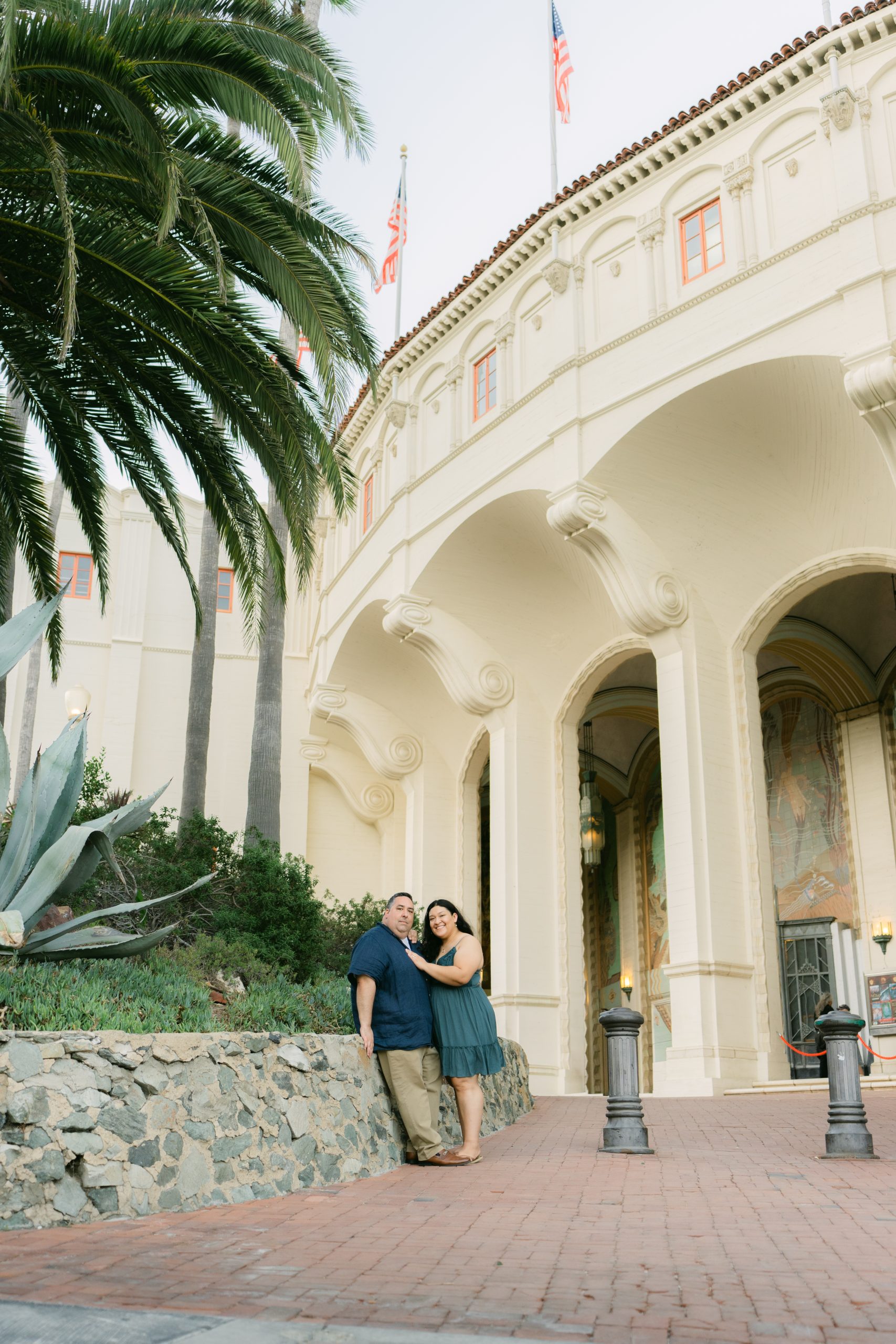 Couple at the colonnade outside the Catalina Casino at golden hour, Avalon California